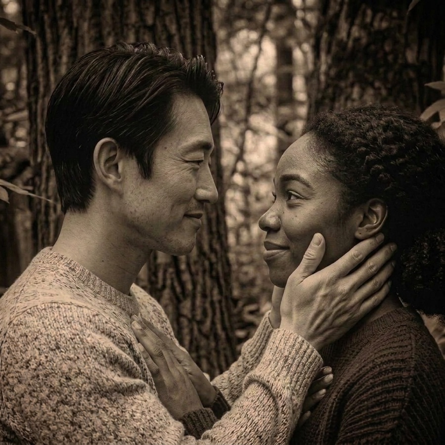 A man gently holding a woman’s face as they smile at each other